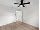 Bedroom featuring light wood-look flooring and a large closet, with a modern ceiling fan at 7085 Willowwood St, Orlando, FL 32818