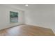 Empty bedroom with hardwood floors, a window, and neutral-colored walls offering a blank canvas at 7085 Willowwood St, Orlando, FL 32818