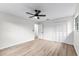Bedroom with light wood-look flooring, ceiling fan, and view of door to another room at 7085 Willowwood St, Orlando, FL 32818