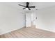 Bedroom featuring light wood floors, a ceiling fan, and access to closet and bathroom at 7085 Willowwood St, Orlando, FL 32818