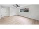 Spacious bedroom featuring light wood-look flooring, closet, and view outside the window at 7085 Willowwood St, Orlando, FL 32818
