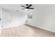 Bedroom featuring light wood-look floors and a closet, illuminated by a modern ceiling fan at 7085 Willowwood St, Orlando, FL 32818
