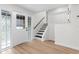 Bright entryway with wood laminate flooring and stairs to the second floor at 7085 Willowwood St, Orlando, FL 32818