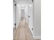 Hallway features light wood floors, white trim, and access to multiple rooms at 7085 Willowwood St, Orlando, FL 32818