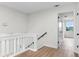 Bright hallway features light wood floors and a white railing and trim at 7085 Willowwood St, Orlando, FL 32818