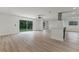 Spacious living room with wood laminate flooring and glass sliding doors to the back yard at 7085 Willowwood St, Orlando, FL 32818