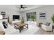 Comfortable living room with a white couch, stylish decor, and a sliding glass door to the outdoor patio at 7085 Willowwood St, Orlando, FL 32818