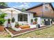 Outdoor living space featuring an inviting patio with comfortable seating, plants and stylish accents at 7085 Willowwood St, Orlando, FL 32818