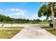 View from the house looking out onto a quiet street with an open field in the distance at 7085 Willowwood St, Orlando, FL 32818