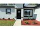 Well-manicured front yard with new landscaping and black trim on a modern gray home at 7382 Sw 129Th Ln, Ocala, FL 34473