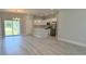 Open-concept kitchen with stainless steel appliances, white cabinets and an island with countertop seating at 7382 Sw 129Th Ln, Ocala, FL 34473