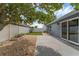 Backyard featuring gravel landscaping, a patio, and white fencing at 7998 Harbor Bend Cir, Orlando, FL 32822