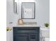 Bathroom featuring a sleek vanity with granite countertop and a modern framed mirror at 7998 Harbor Bend Cir, Orlando, FL 32822