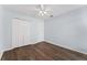 Bedroom featuring light blue walls, a ceiling fan, and wood flooring at 7998 Harbor Bend Cir, Orlando, FL 32822