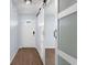 Welcoming entryway showcasing a white front door, wood-look flooring, and a stylish sliding barn door at 7998 Harbor Bend Cir, Orlando, FL 32822