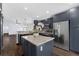 Well-equipped kitchen with granite countertops, navy blue cabinetry, stainless steel appliances, and island bar at 7998 Harbor Bend Cir, Orlando, FL 32822