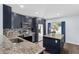 Modern kitchen featuring navy blue cabinets, granite countertops, stainless steel appliances, and center island at 7998 Harbor Bend Cir, Orlando, FL 32822