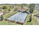 Aerial view of a community basketball court, fenced in and surrounded by lush landscaping and trees at 8413 Sw 54Th Loop, Ocala, FL 34481