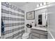 Well-lit bathroom featuring a vanity, toilet, and a shower with patterned curtain at 8413 Sw 54Th Loop, Ocala, FL 34481