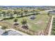 An aerial view of the fenced dog park equipped with a gazebo, play structures, and water stations at 8413 Sw 54Th Loop, Ocala, FL 34481