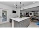 Bright kitchen island with modern lighting, stainless appliances, and sleek countertops at 8413 Sw 54Th Loop, Ocala, FL 34481