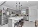 Modern kitchen featuring stainless steel appliances, center island with seating and gray cabinets at 8413 Sw 54Th Loop, Ocala, FL 34481
