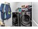 Neat laundry room features modern washer and dryer with shelving at 8413 Sw 54Th Loop, Ocala, FL 34481