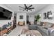 Comfortable living room with large gray couch, decorative rug, and modern entertainment system at 8413 Sw 54Th Loop, Ocala, FL 34481