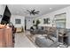 Cozy living room with sectional couch, large windows, and entertainment setup at 8413 Sw 54Th Loop, Ocala, FL 34481