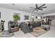 Spacious living room featuring a modern ceiling fan, comfortable seating, and an open layout at 8413 Sw 54Th Loop, Ocala, FL 34481