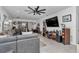 Bright and open living room featuring modern decor, a large TV, and an open layout at 8413 Sw 54Th Loop, Ocala, FL 34481
