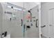 Modern shower features glass door, grab bars, and a convenient built-in shelf for storage at 8413 Sw 54Th Loop, Ocala, FL 34481