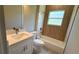This bathroom features a tub with tiled walls, a toilet, and a stylish vanity with modern fixtures at 851 Marion Oaks Mnr, Ocala, FL 34473