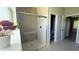 Modern bathroom with a glass-enclosed shower and an open doorway to the toilet and vanity area at 851 Marion Oaks Mnr, Ocala, FL 34473
