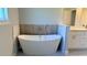 Bright bathroom showcasing a modern soaking tub with a handheld shower and a dual vanity at 851 Marion Oaks Mnr, Ocala, FL 34473