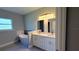 Bathroom featuring a modern soaking tub, dual vanity, and decorative lighting at 851 Marion Oaks Mnr, Ocala, FL 34473