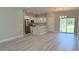 Bright, open-concept kitchen and living area with stainless steel appliances, white cabinets, and ample natural light at 851 Marion Oaks Mnr, Ocala, FL 34473