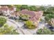 Aerial view of a residential building with parking and mature trees at 12220 Wild Iris Way # 103, Orlando, FL 32837