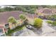 Aerial view of a residential building with parking and mature trees at 12220 Wild Iris Way # 103, Orlando, FL 32837