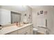 Well-lit bathroom with a vanity, decorative prints, and a shower featuring a patterned curtain at 12220 Wild Iris Way # 103, Orlando, FL 32837