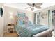 Bright bedroom with a tufted headboard, ceiling fan, large windows, and a curated display of decor at 12220 Wild Iris Way # 103, Orlando, FL 32837