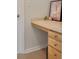 Built-in desk area featuring wooden drawers, a countertop, and natural lighting at 12220 Wild Iris Way # 103, Orlando, FL 32837