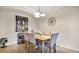 The dining room features a light-colored table with seating for six and decorative accents and lighting at 12220 Wild Iris Way # 103, Orlando, FL 32837