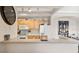 Functional kitchen featuring light wood cabinets, white appliances, and a breakfast bar overlooking the dining area at 12220 Wild Iris Way # 103, Orlando, FL 32837
