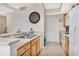 Efficient kitchen area with light wood cabinets, a breakfast bar, and white appliances at 12220 Wild Iris Way # 103, Orlando, FL 32837