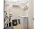 Functional laundry room equipped with a washing machine, shelving, and storage solutions at 12220 Wild Iris Way # 103, Orlando, FL 32837