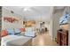 Open-concept living space with light wood floors, a comfortable sofa, and seamlessly connected dining and kitchen areas at 12220 Wild Iris Way # 103, Orlando, FL 32837