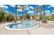 Community pool with clear blue water, surrounded by palm trees and lounge seating at 12220 Wild Iris Way # 103, Orlando, FL 32837