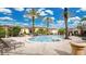 Community pool area with lounge chairs, palm trees, and well-maintained grounds at 12220 Wild Iris Way # 103, Orlando, FL 32837