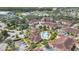 Aerial view of condominium complex with community pool and lush landscaping, and mature trees at 12220 Wild Iris Way # 103, Orlando, FL 32837